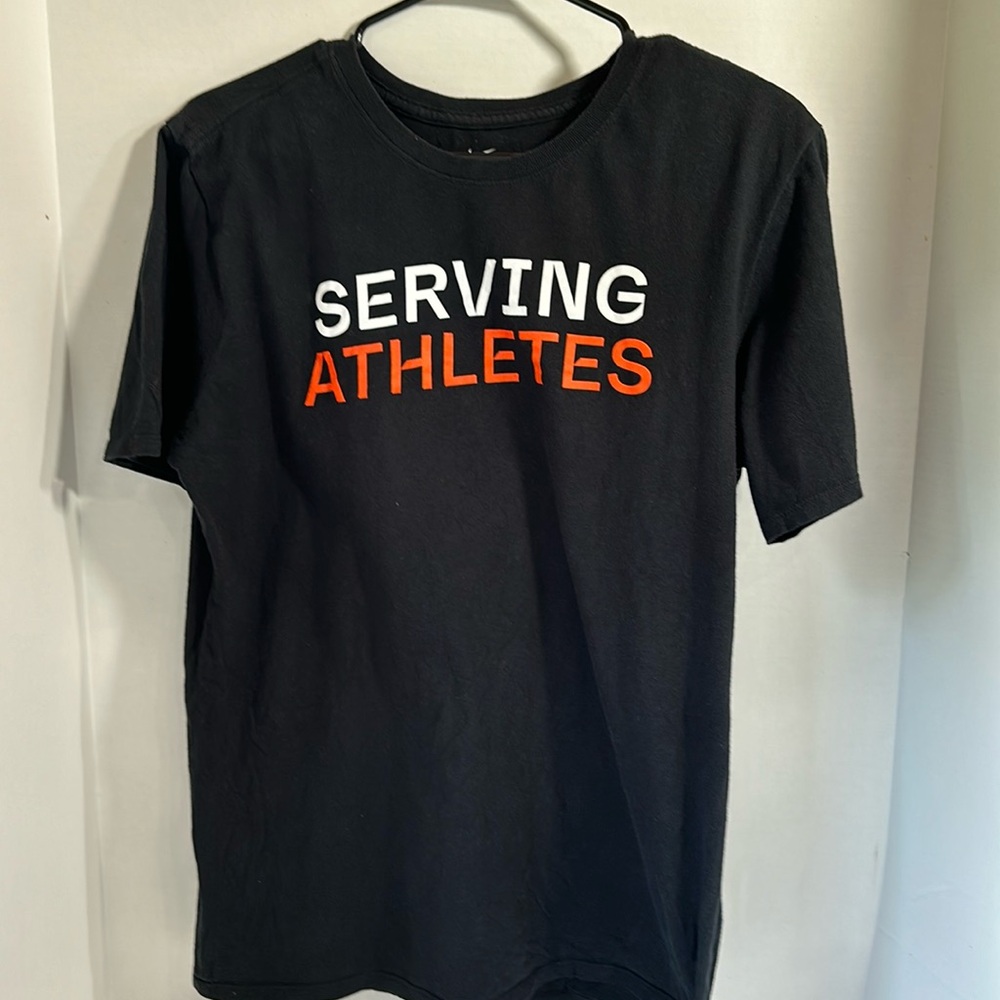 The Nike tee athletic cut black tee shirt serving athletes size medium
